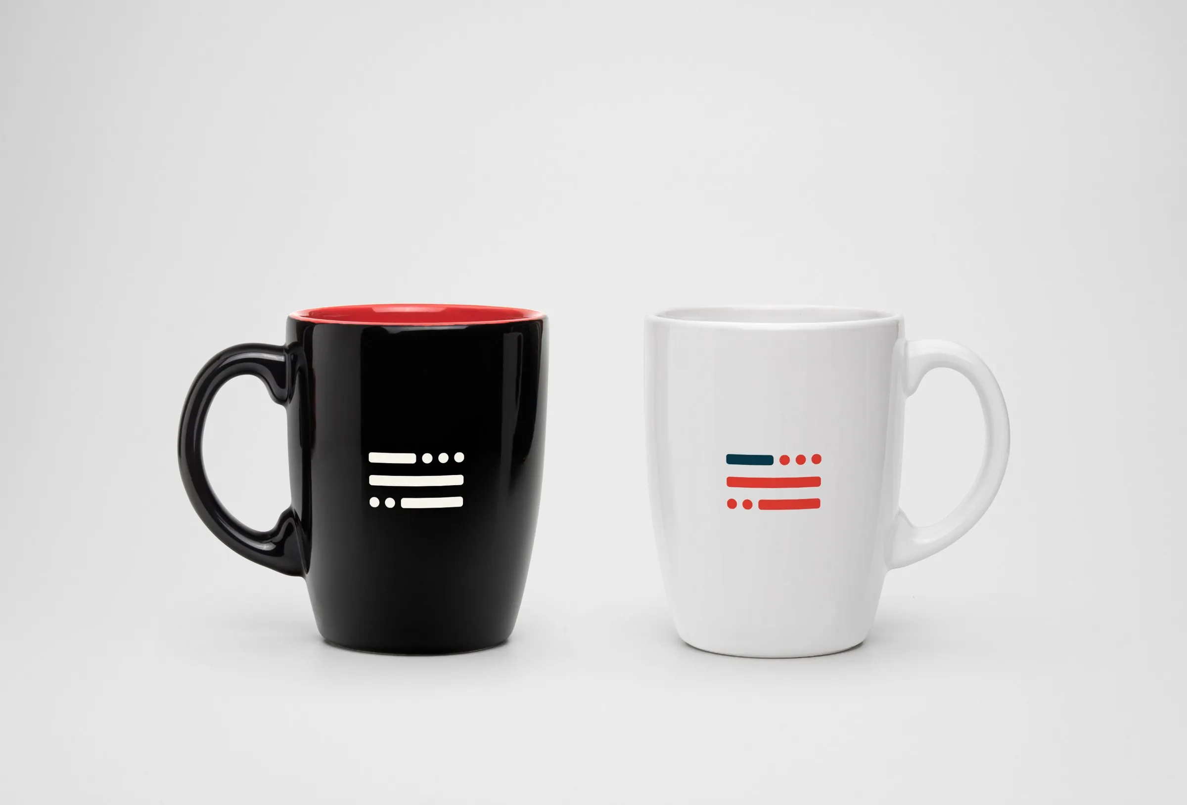 Navy and warm red mugs with the flag and the wordmark