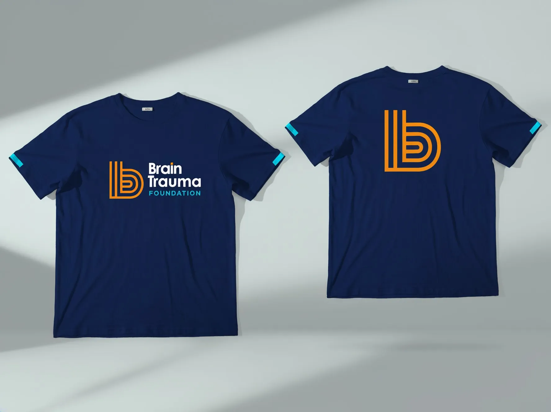 Two navy T-shirts with the logo and the b